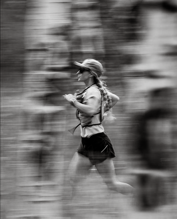 A female trail runner in the woods